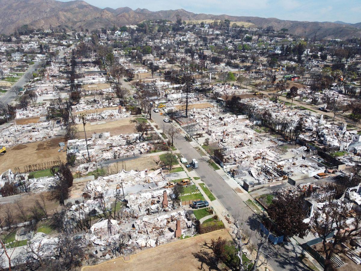 March 22, 2025, Pacific Palisades, California, United States: Owners of a house that destroyed during the fire stand on the ash of their home. Pacific Palisades was one of the cities most severely affected by the Palisades wildfire in January 2025, with thousands of houses and businesses consumed by flames and leaving only ash behind, displacing many residents and devastating the community. Two months later, reconstruction efforts are in full swing as workers clear away ash and burnt materials in the first phase of rebuilding, while simultaneously working to restore essential utilities and help residents reclaim their homes and livelihoods as quickly as possible. 22 Mar 2025 Pictured: March 22, 2025, Pacific Palisades, California, United States: The aerial view of the burnt houses that left ash behind at Pacific Palisades.(Editor's note: Image taken by drone.) Pacific Palisades was one of the cities most severely affected by the Palisades wildfire in January 2025, with thousands of houses and businesses consumed by flames and leaving only ash behind, displacing many residents and devastating the community. Two months later, reconstruction efforts are in full swing as workers clear away ash and burnt materials in the first phase of rebuilding, while simultaneously working to restore essential utilities and help residents reclaim their homes and livelihoods as quickly as possible. Photo credit: ZUMAPRESS.com / MEGA TheMegaAgency.com sales@mega.global